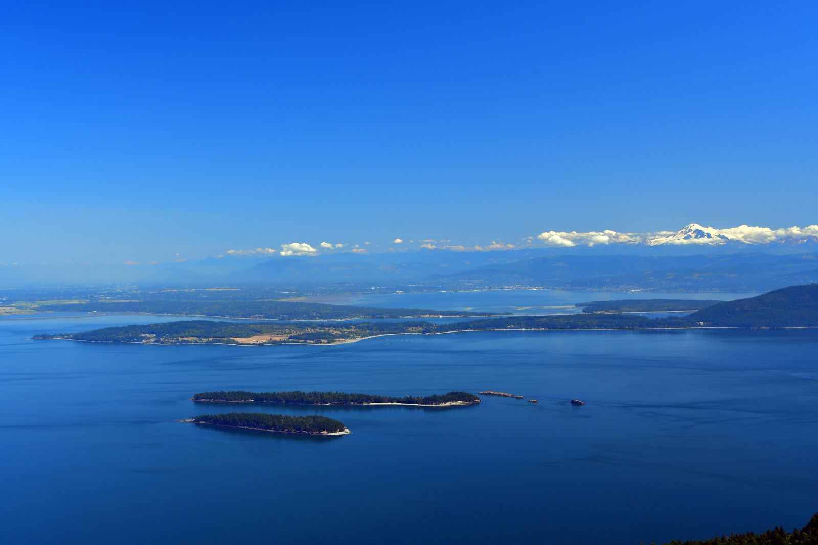 peak of Mt. Constitution overlooking snowy Mt. Baker and Mt. Rainier
