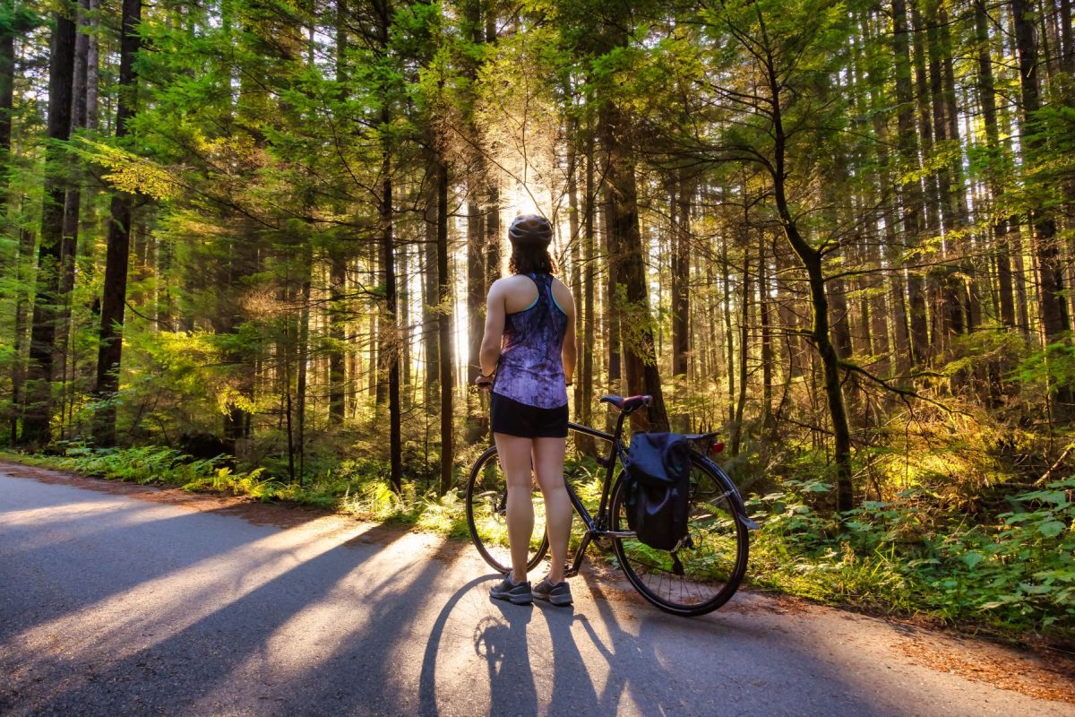 woman biking in a forest
